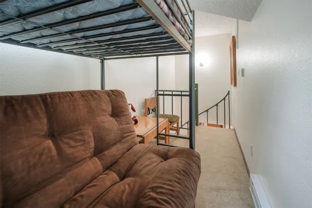 a bedroom with a bed and a lamp