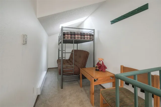 a bedroom with a bed and a table in it