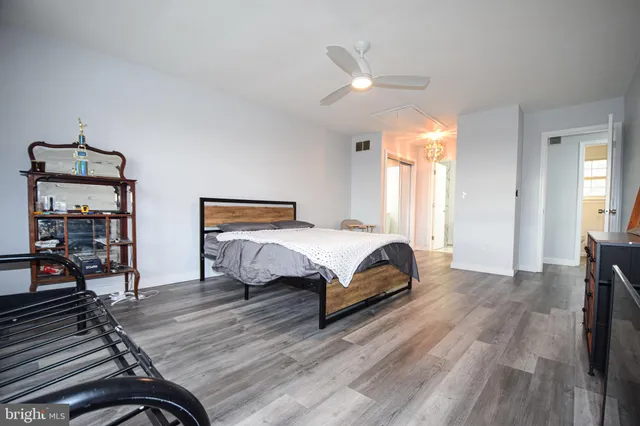 a bedroom with a bed and wooden floor