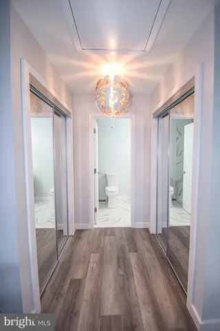 a view of empty room with wooden floor