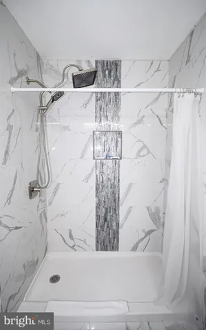 a bathroom with a bathtub and shower