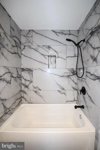 a bathroom with a bathtub and shower