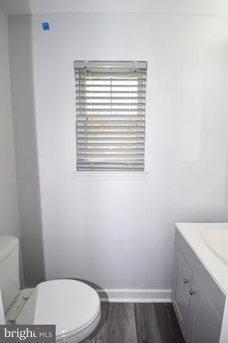 a bathroom with a toilet and a window