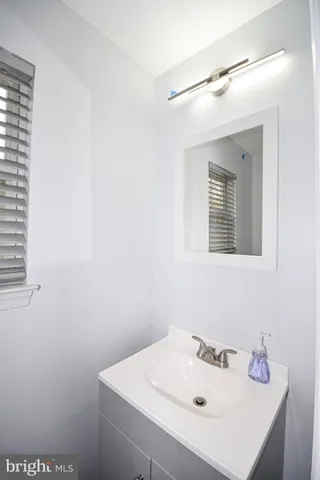 a bathroom with a sink a mirror and vanity