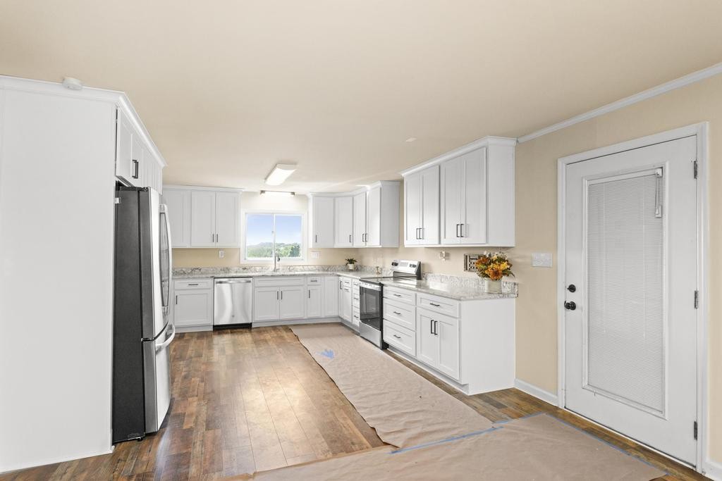 1029 Robertson Road Gallatin, TN 37066 - Photo 11 of 62 a kitchen with white cabinets and white appliances