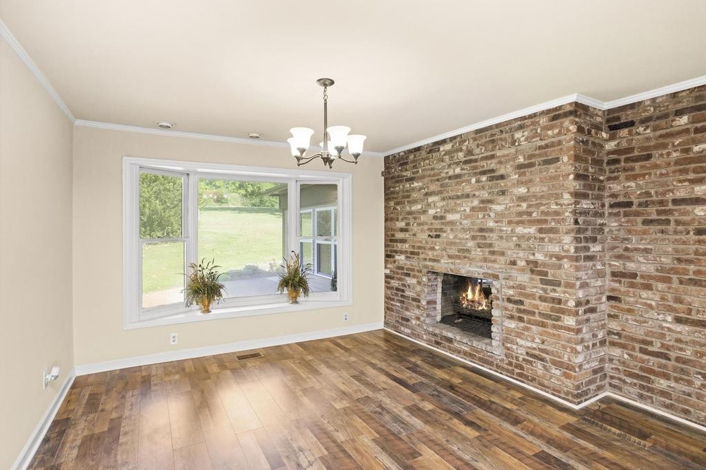 1029 Robertson Road Gallatin, TN 37066 - Photo 12 of 62 a view of an empty room with wooden floor and a fireplace