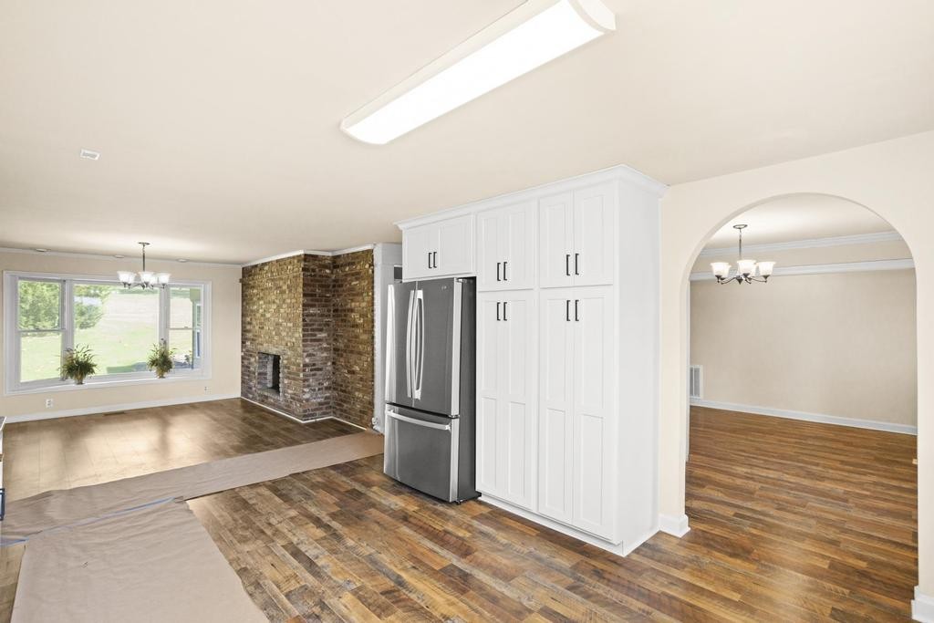 1029 Robertson Road Gallatin, TN 37066 - Photo 15 of 62 a view of a kitchen with wooden floor and a refrigerator