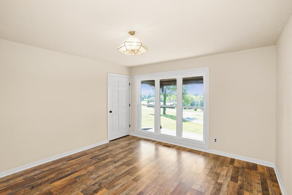 1029 Robertson Road Gallatin, TN 37066 - Photo 22 of 62 an empty room with wooden floor and windows