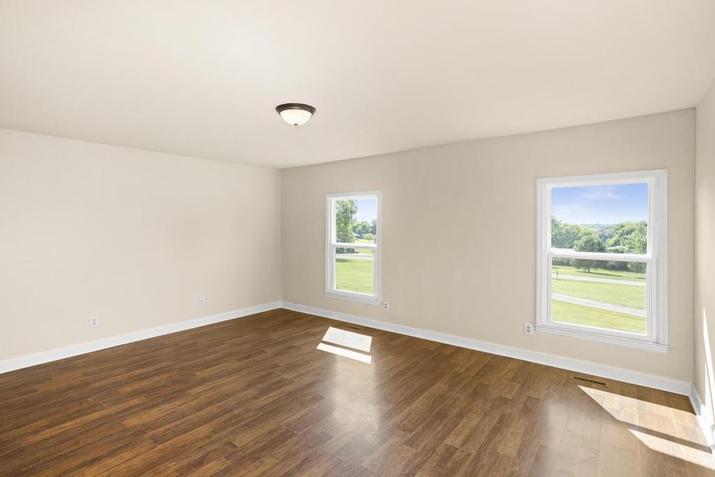 1029 Robertson Road Gallatin, TN 37066 - Photo 24 of 62 an empty room with wooden floor and windows