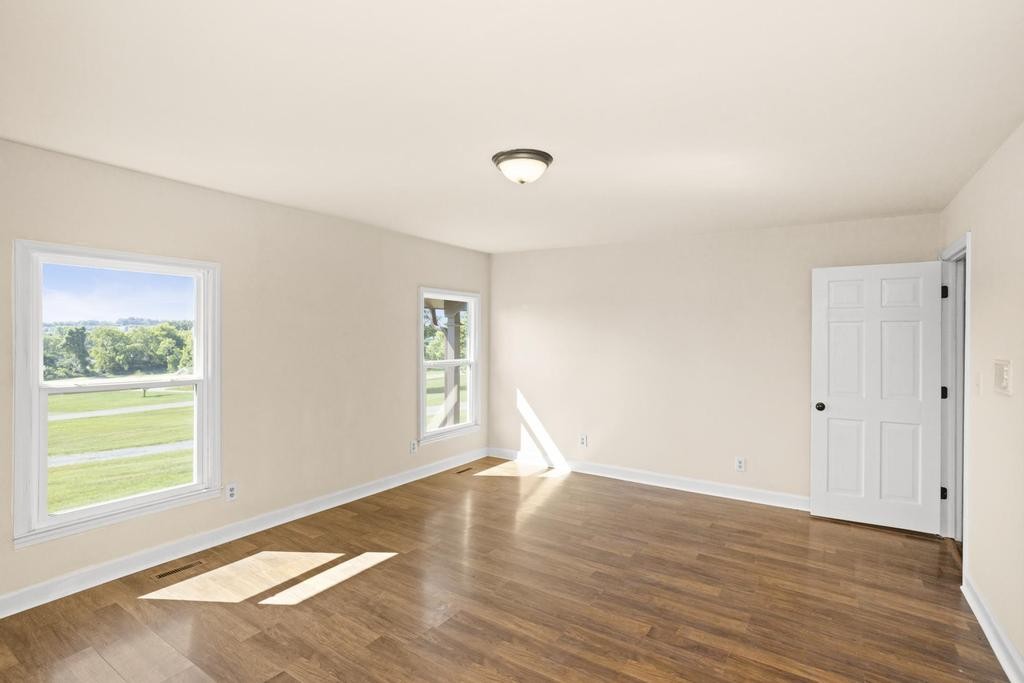 1029 Robertson Road Gallatin, TN 37066 - Photo 25 of 62 an empty room with wooden floor and windows