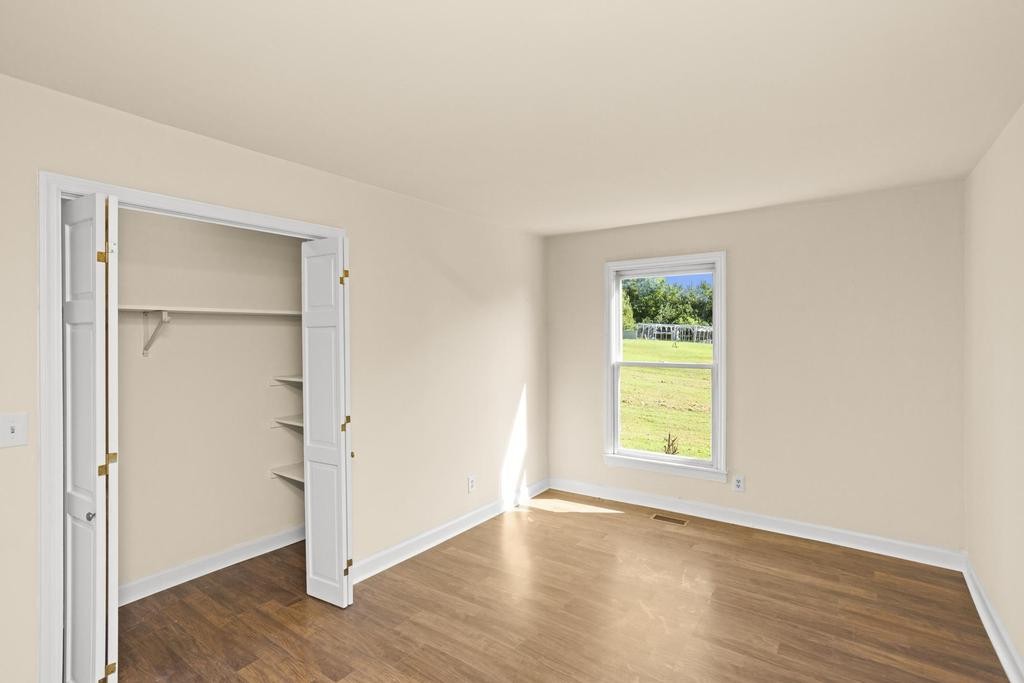 1029 Robertson Road Gallatin, TN 37066 - Photo 28 of 62 an empty room with wooden floor closet and windows