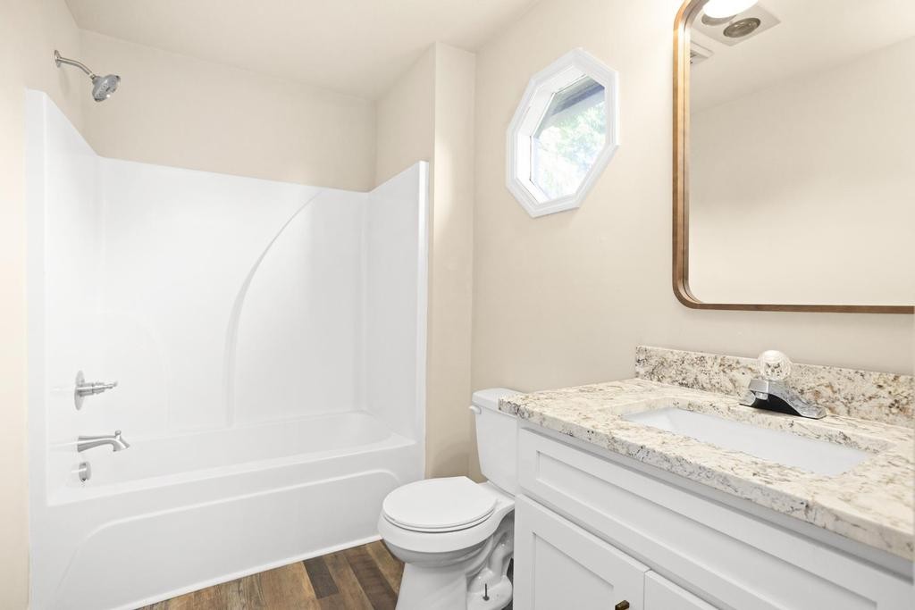 1029 Robertson Road Gallatin, TN 37066 - Photo 35 of 62 a bathroom with a granite countertop sink a toilet and a bathtub