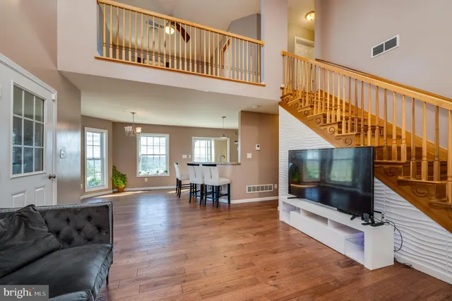 a view of a dining room with furniture windows and wooden floor