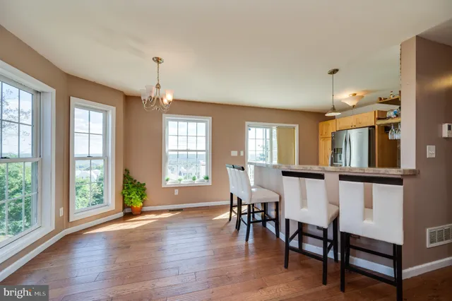 a dining room with furniture and wooden floor