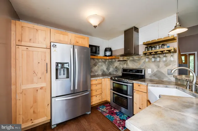 a kitchen with stainless steel appliances granite countertop a stove and a sink