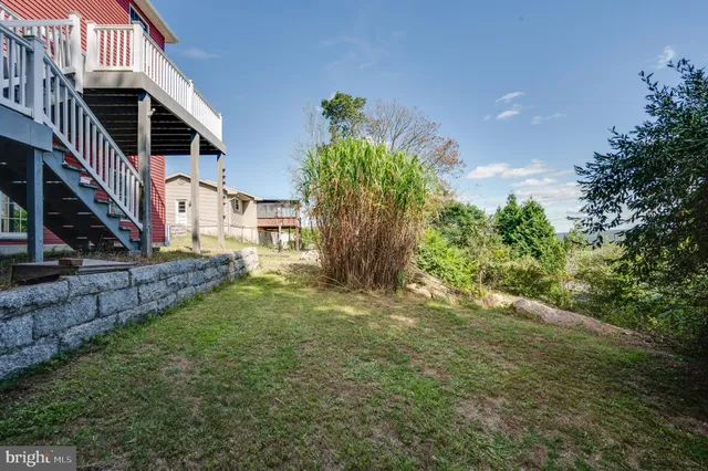 a view of a backyard with plants and patio