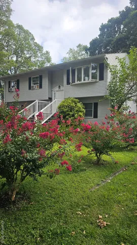 a front view of house with yard and green space