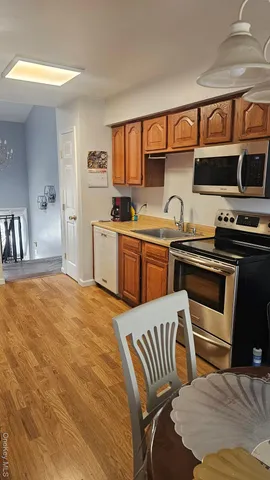 a kitchen with stainless steel appliances a stove a sink and a refrigerator
