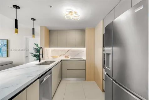a kitchen with a sink and refrigerator
