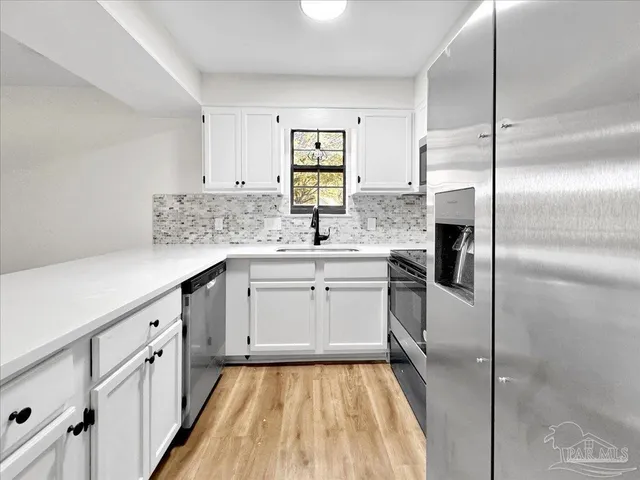 a view of kitchen with microwave and cabinets