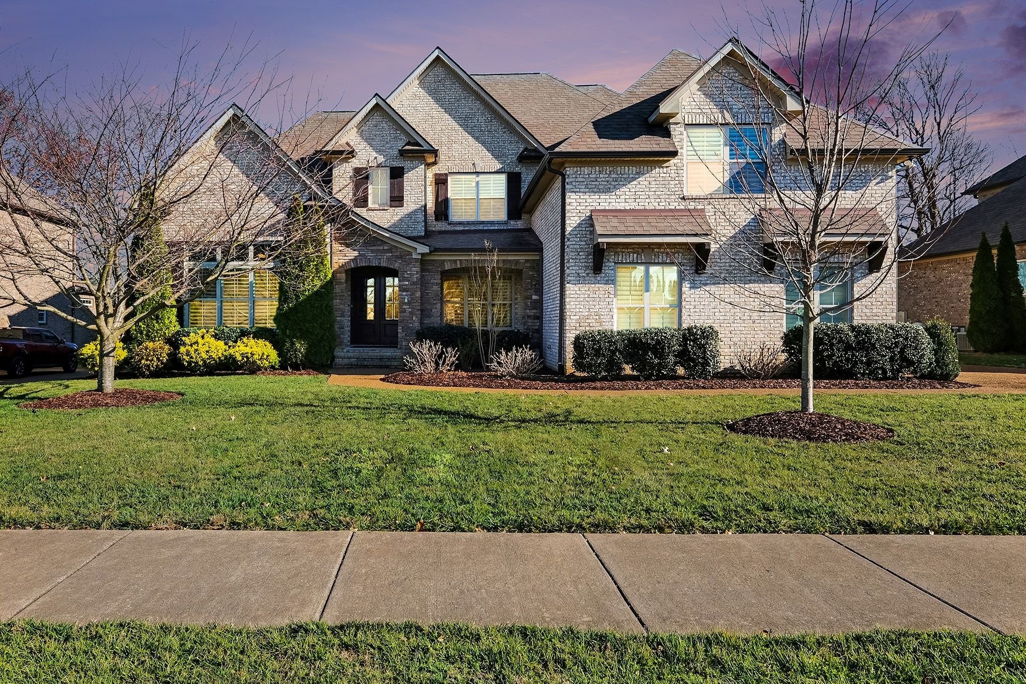a front view of a house with a yard