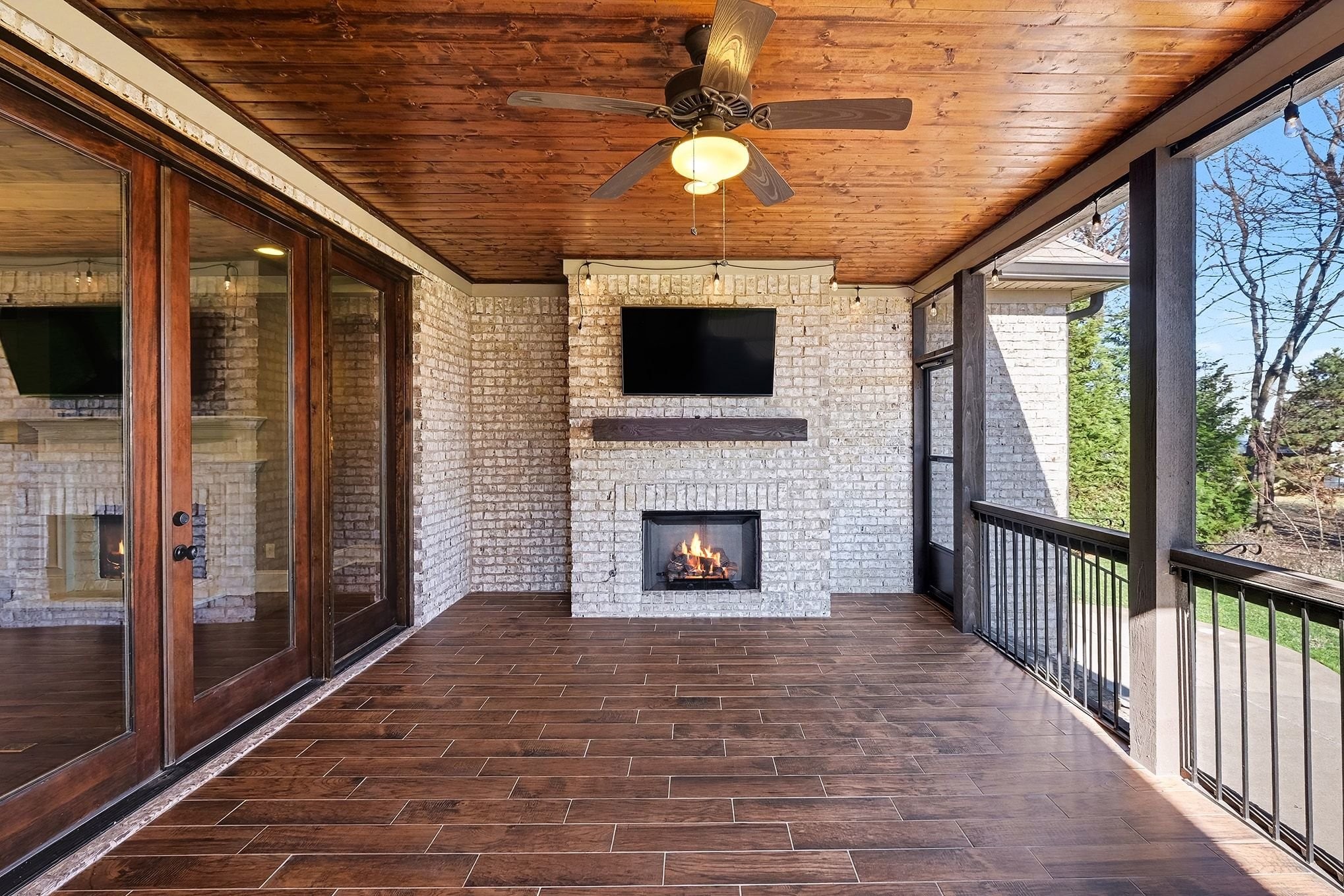 2015 Autumn Ridge Way Spring Hill, TN 37174 - Photo 7 of 42 a living room with a fireplace furniture a flat screen tv and a floor to ceiling window