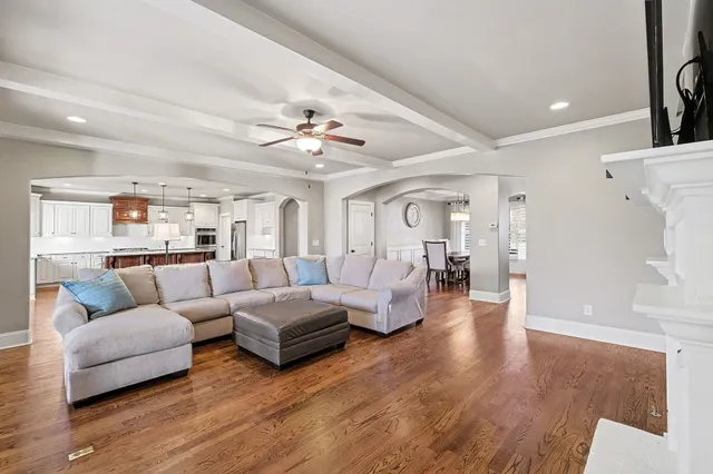 a kitchen with stainless steel appliances granite countertop a sink a stove and a wooden floor