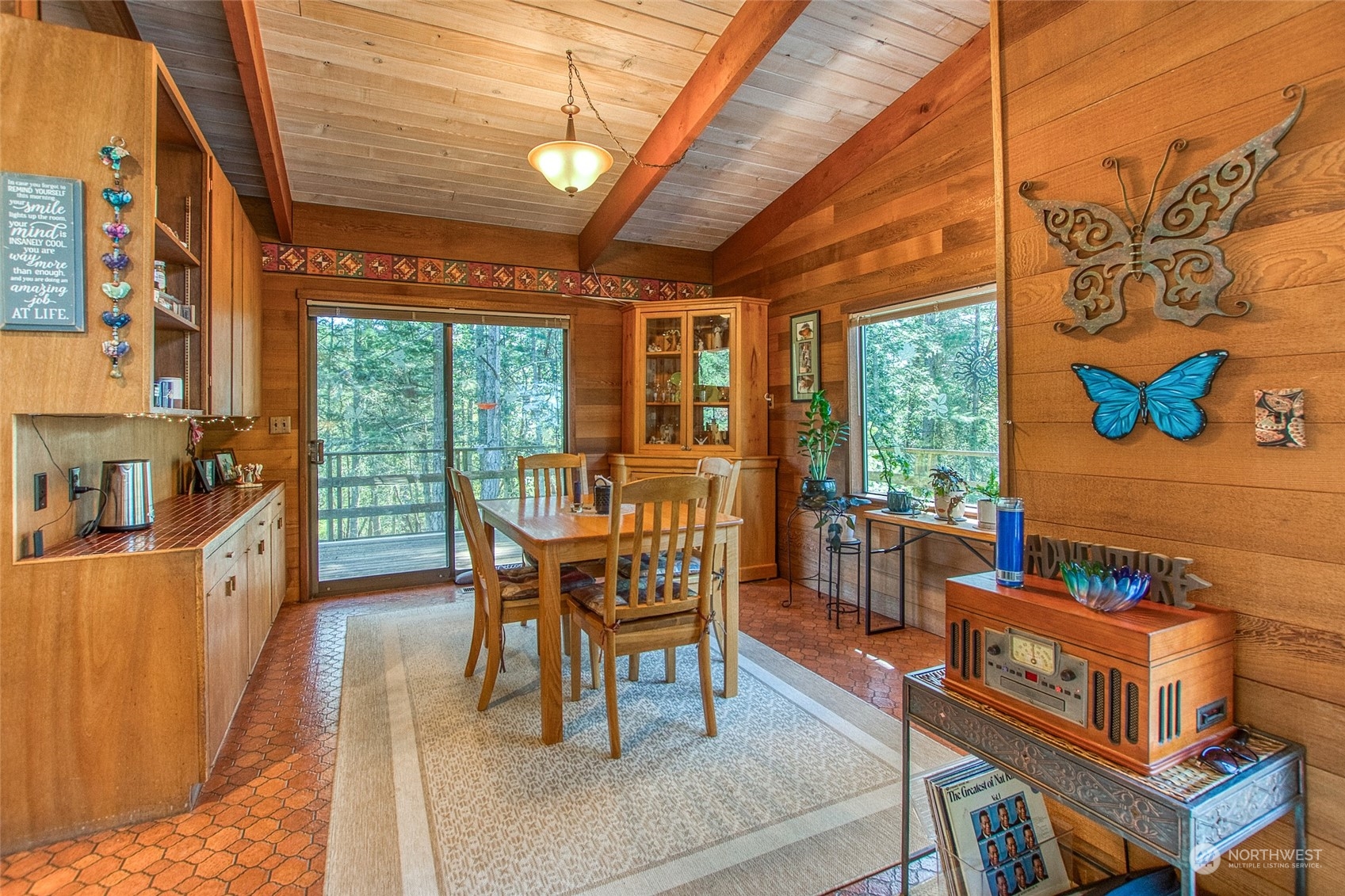 153 Exton Road Orcas Island, WA 98280 - Photo 11 of 30 a dining room with furniture and a floor to ceiling window