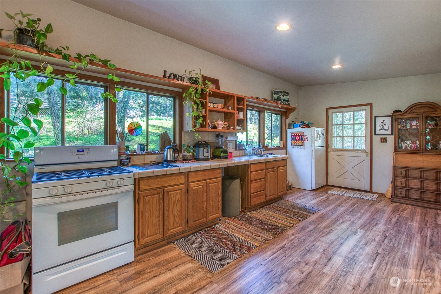 153 Exton Road Orcas Island, WA 98280 - Photo 27 of 30 a kitchen with stainless steel appliances granite countertop wooden floors and sink