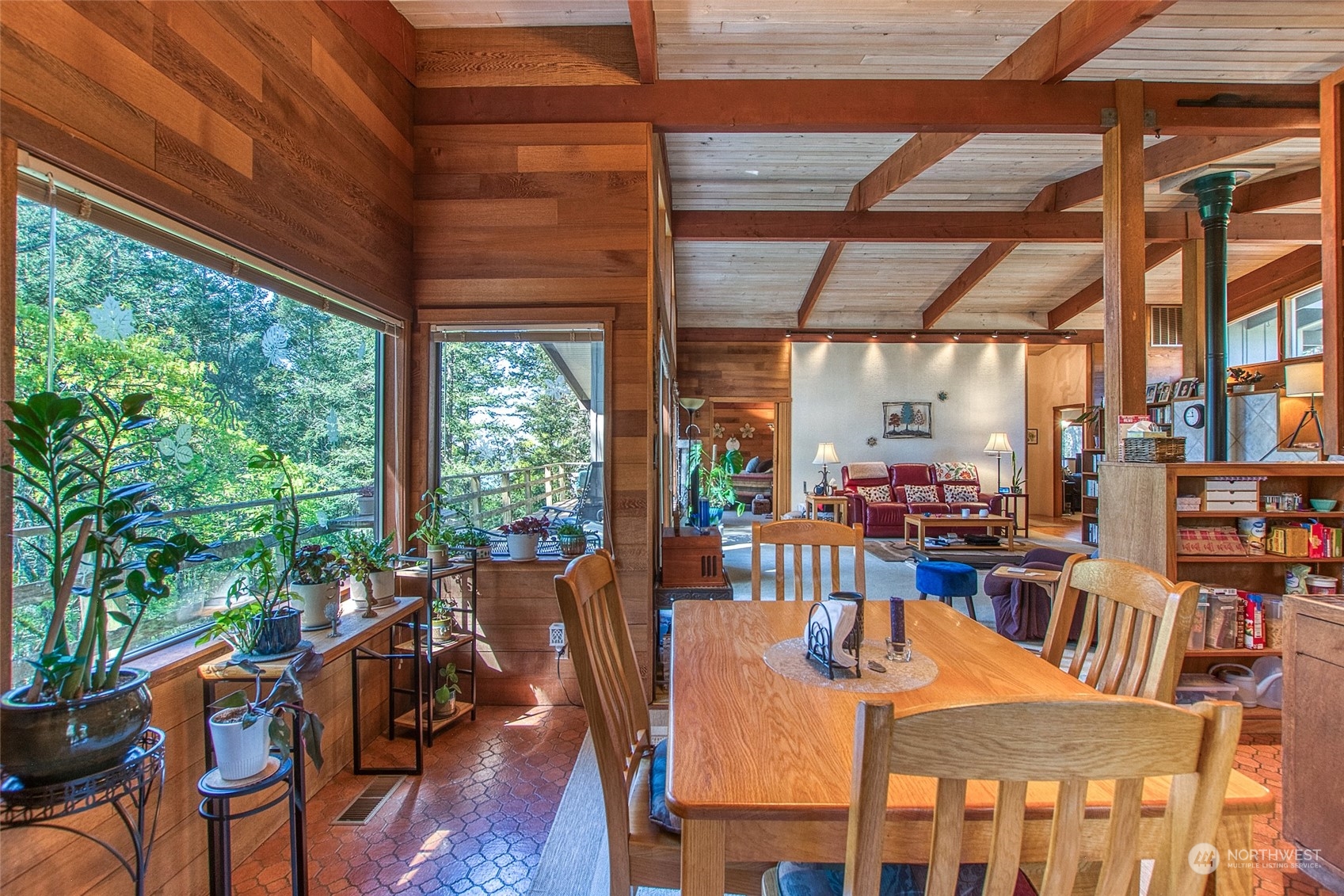 153 Exton Road Orcas Island, WA 98280 - Photo 10 of 30 a dining room with furniture a large window and plants