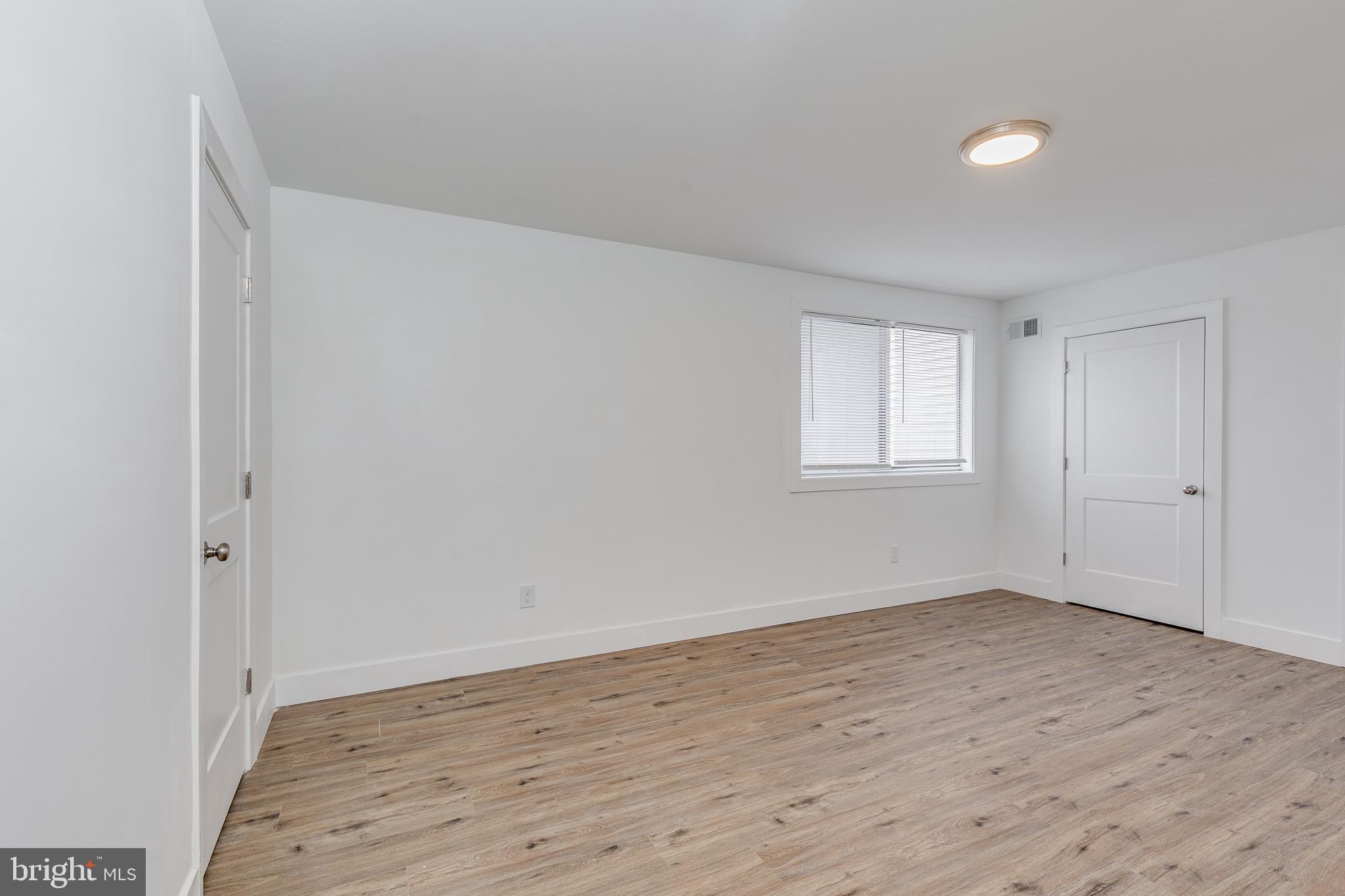 705 Mason Run Pine Hill, NJ 08021 - Photo 19 of 33 a view of an empty room with wooden floor and a window