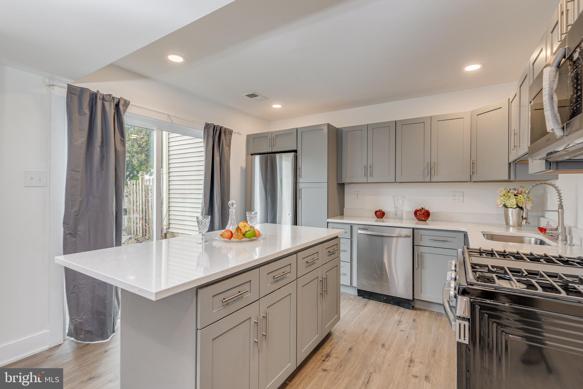 705 Mason Run Pine Hill, NJ 08021 - Photo 6 of 33 a kitchen with a sink stove and cabinets