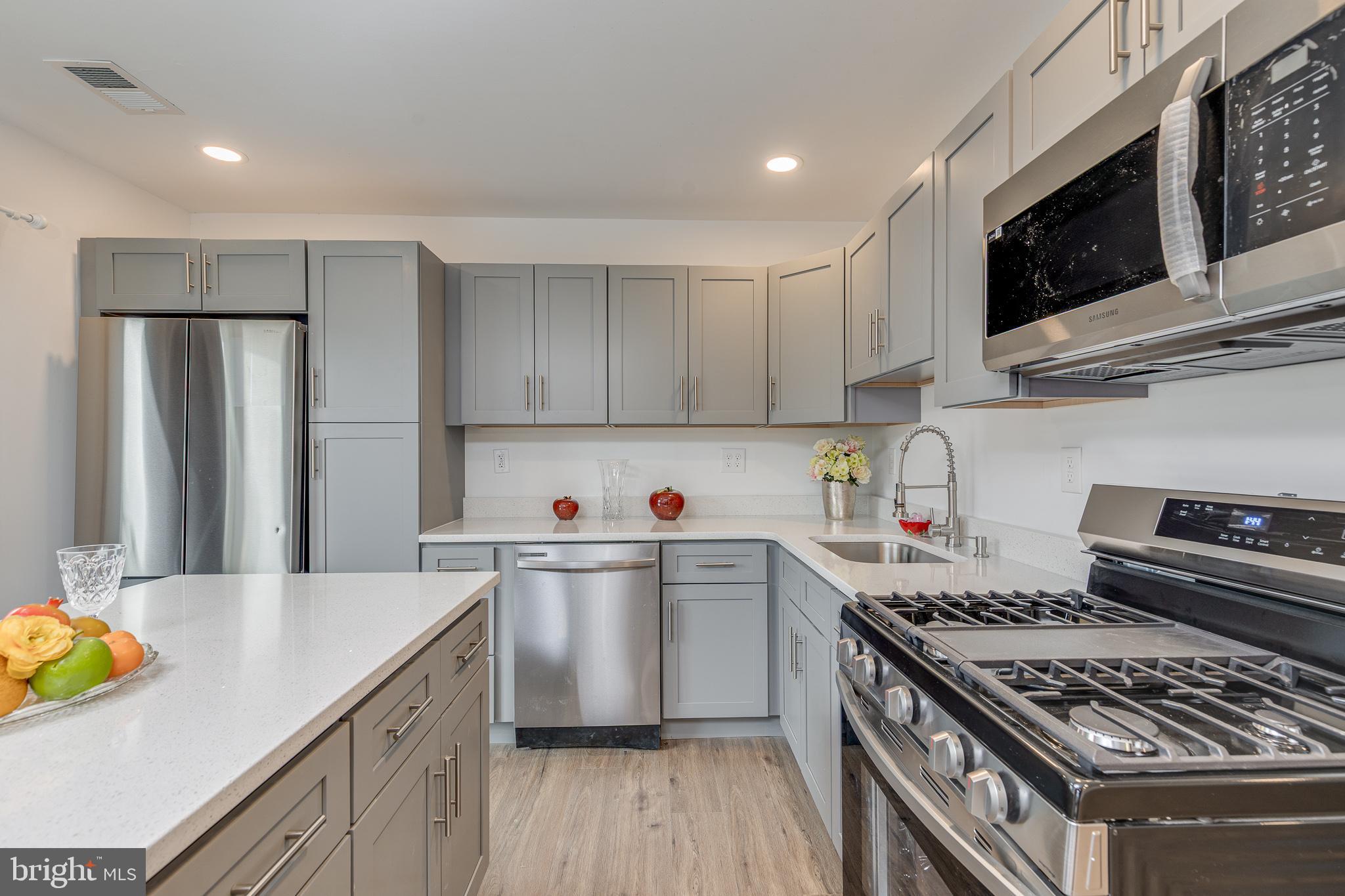 705 Mason Run Pine Hill, NJ 08021 - Photo 7 of 33 a kitchen with stainless steel appliances granite countertop a sink stove and refrigerator