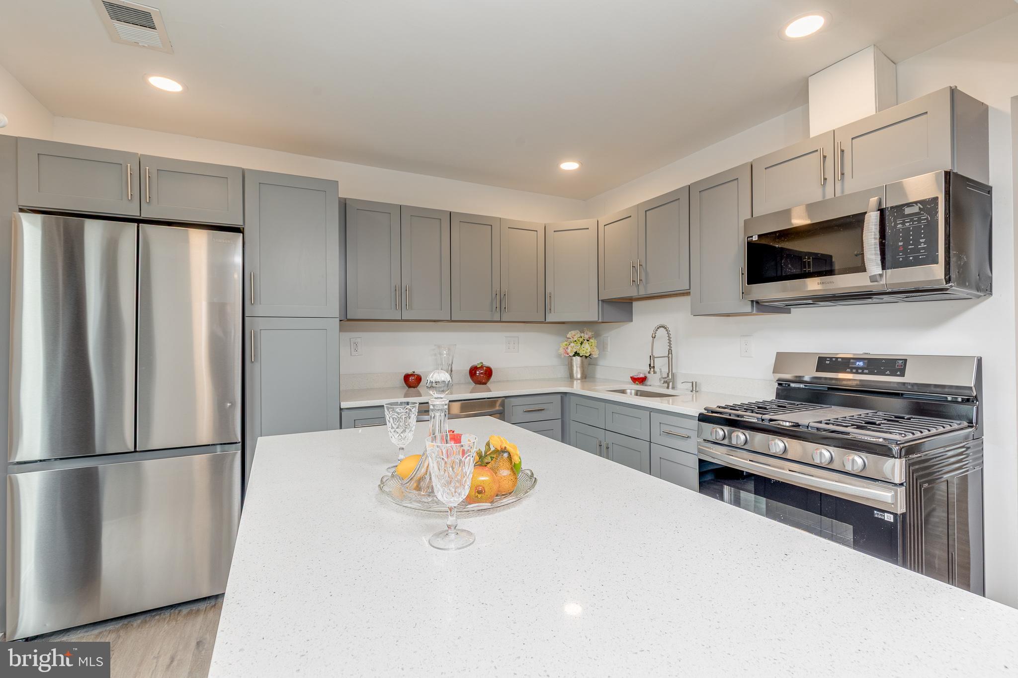 705 Mason Run Pine Hill, NJ 08021 - Photo 9 of 33 a kitchen with stainless steel appliances a refrigerator stove top oven and a sink