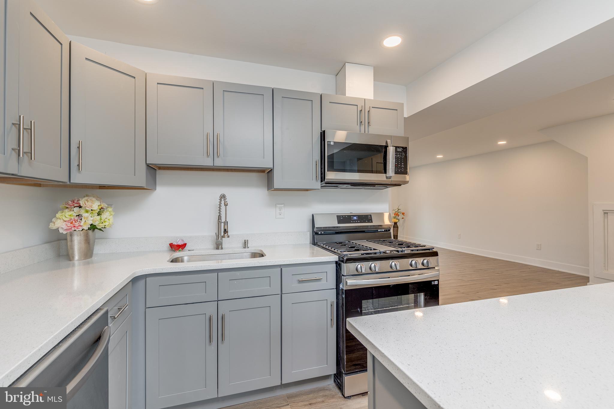 705 Mason Run Pine Hill, NJ 08021 - Photo 10 of 33 a kitchen with a sink a stove and cabinets