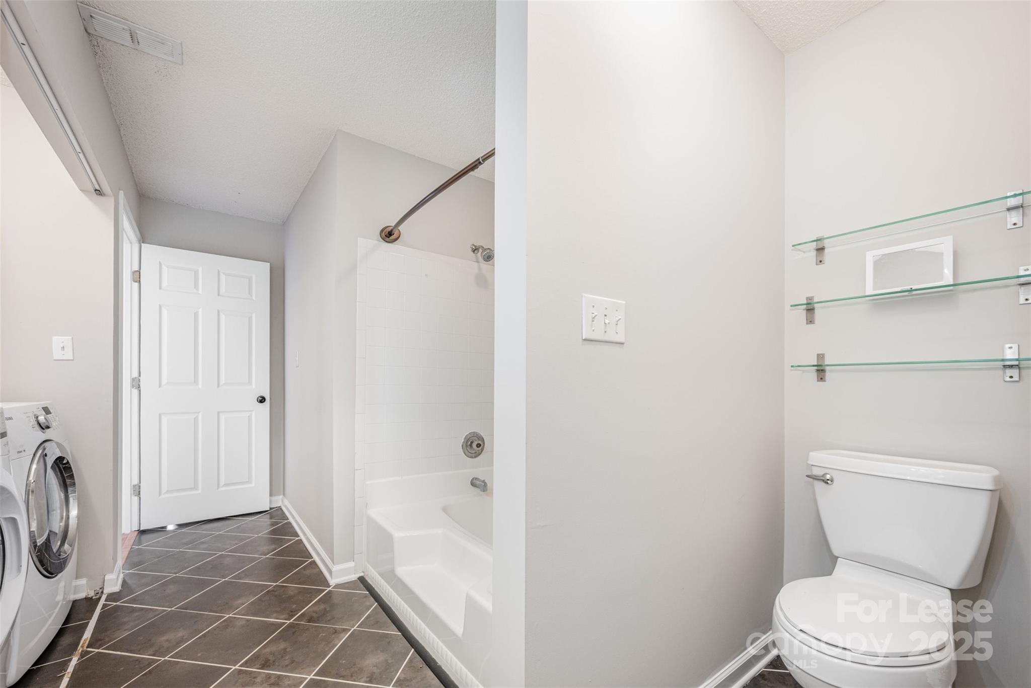 2555 Stockbridge Drive, Unit C Charlotte, NC 28210 - Photo 13 of 19 a bathroom with a toilet and a shower