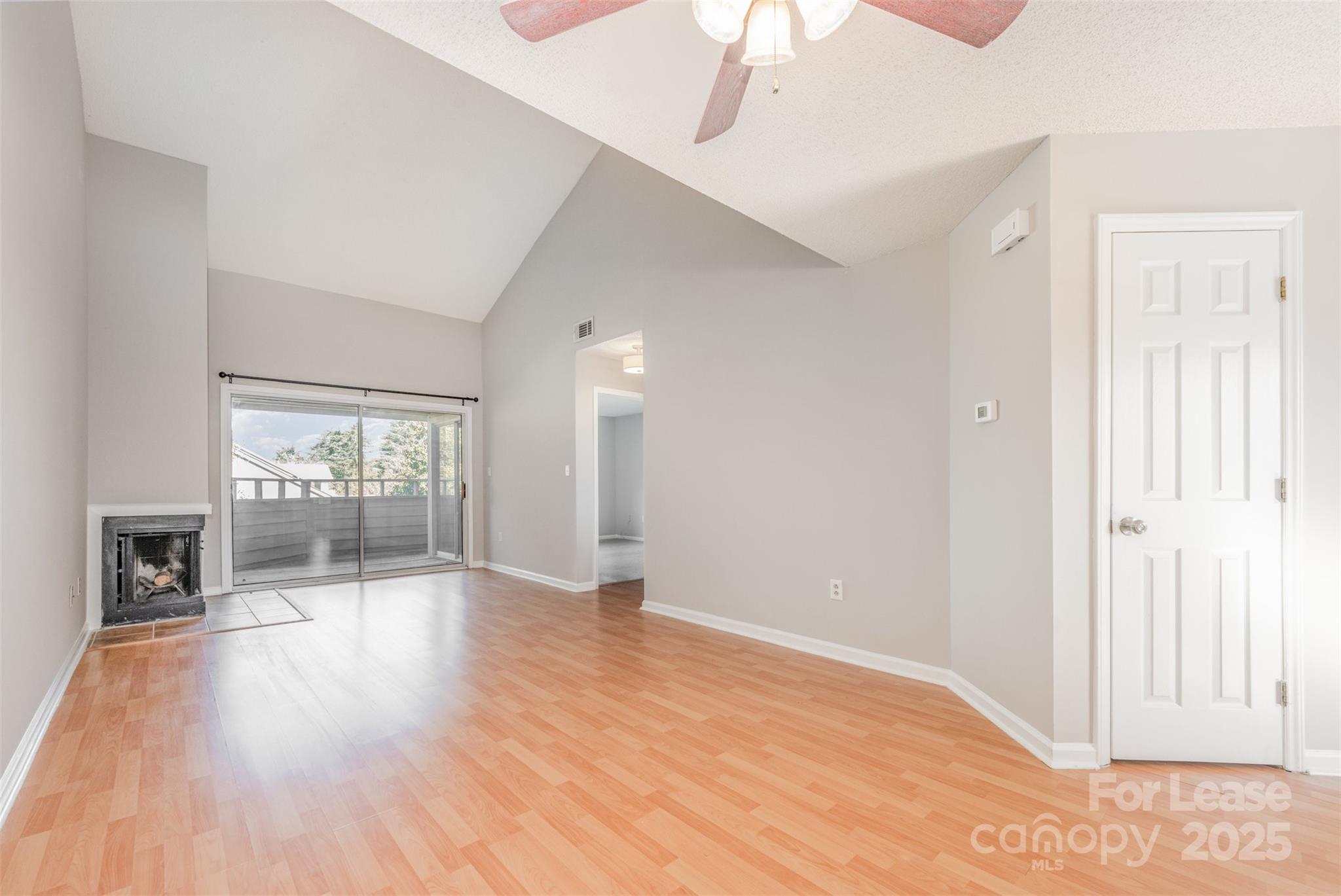 2555 Stockbridge Drive, Unit C Charlotte, NC 28210 - Photo 3 of 19 a view of an empty room with window and wooden floor