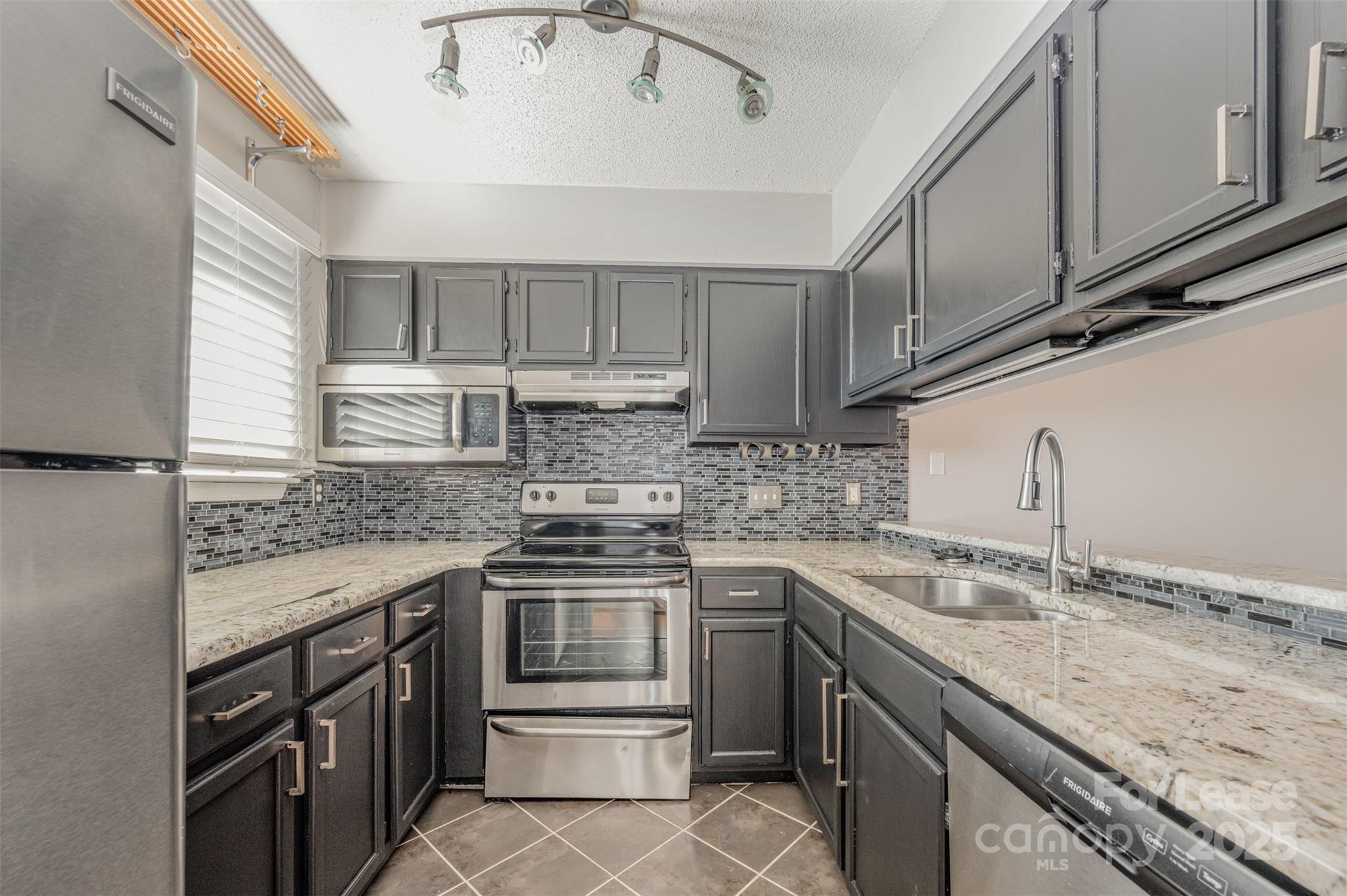 2555 Stockbridge Drive, Unit C Charlotte, NC 28210 - Photo 4 of 19 a kitchen with stainless steel appliances granite countertop a sink stove and cabinets