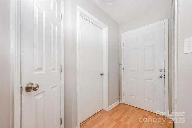 a view of a room with wooden floor