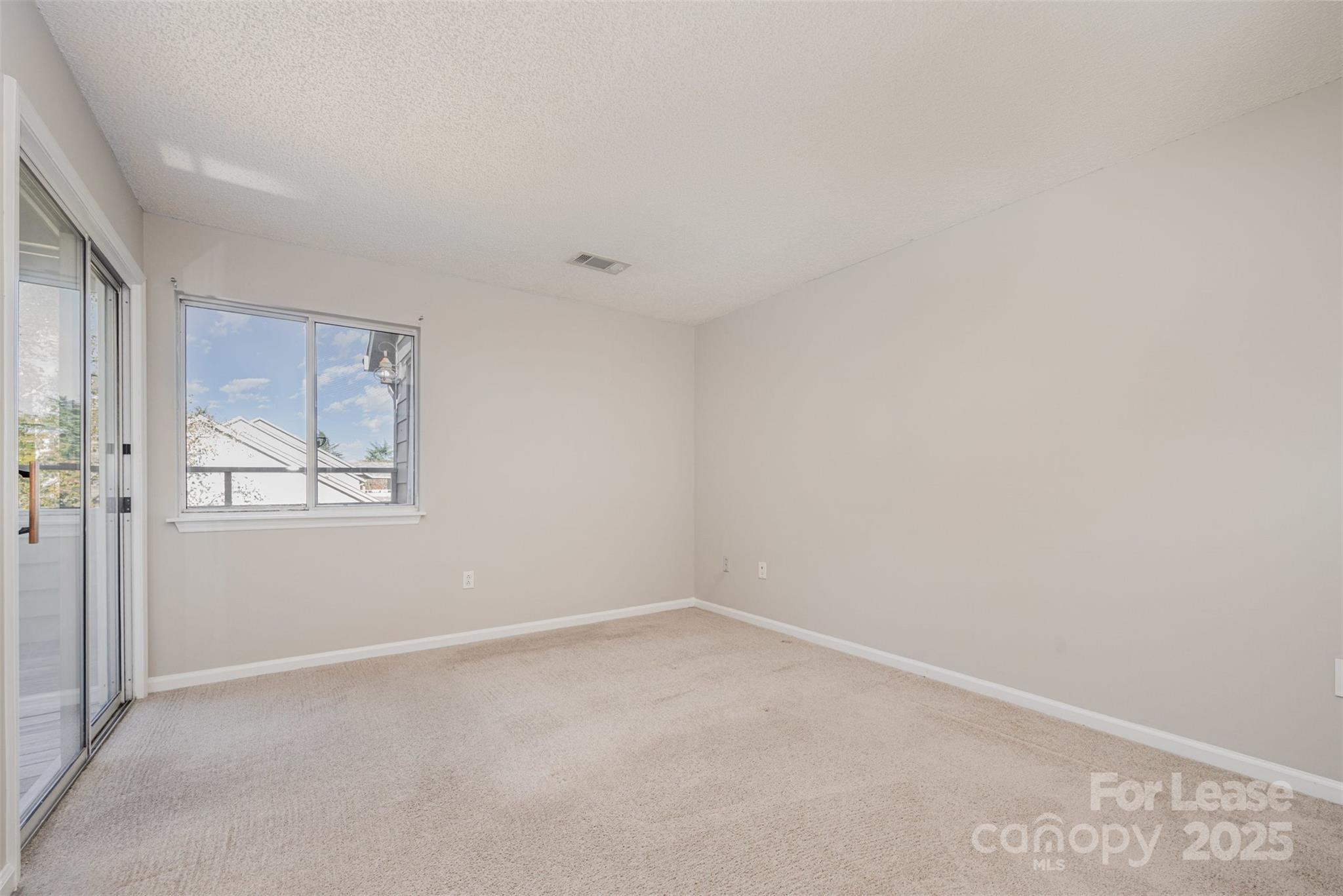 2555 Stockbridge Drive, Unit C Charlotte, NC 28210 - Photo 8 of 19 a view of an empty room with a window