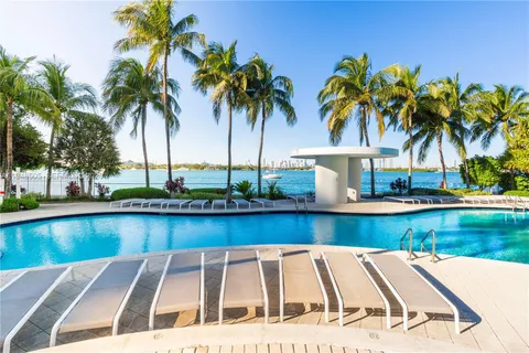 a view of swimming pool with a table and chairs