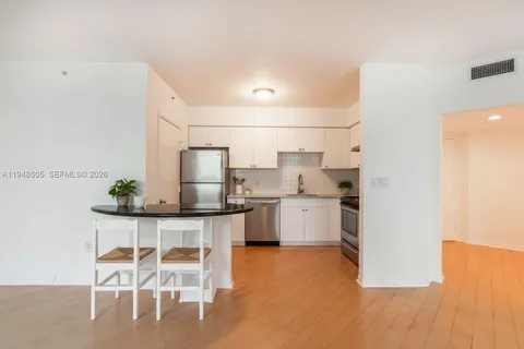 a kitchen with a table and chairs in it