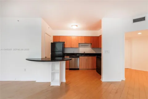 a kitchen with stainless steel appliances a counter top space and cabinets
