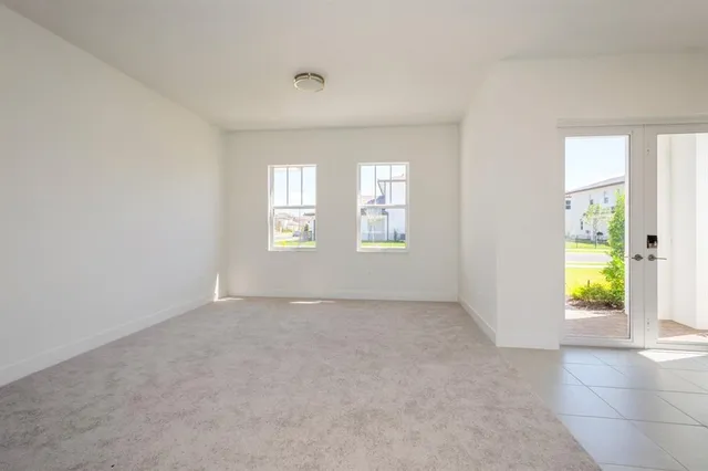 a view of staircase with railing and white walls