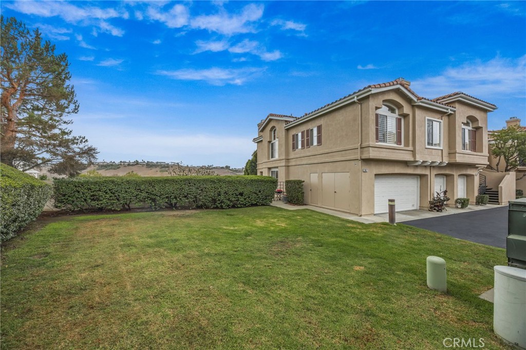 28677 La Azteca Laguna Niguel, CA 92677 - Photo 2 of 36 a view of a white house with a big yard and large trees