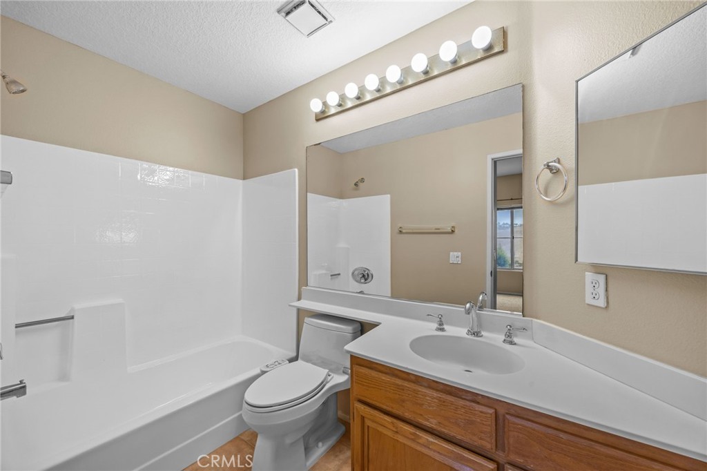 28677 La Azteca Laguna Niguel, CA 92677 - Photo 22 of 36 a bathroom with a sink a toilet a mirror a vanity and shower