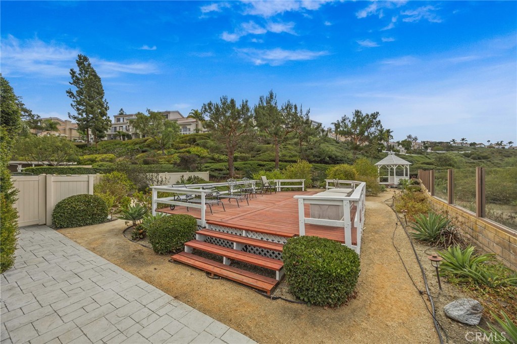 28677 La Azteca Laguna Niguel, CA 92677 - Photo 4 of 36 a balcony with outdoor seating and wooden floor