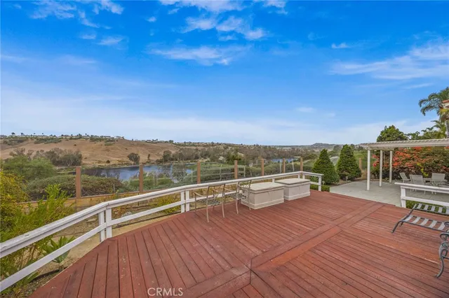 an empty room with wooden floor fireplace and windows