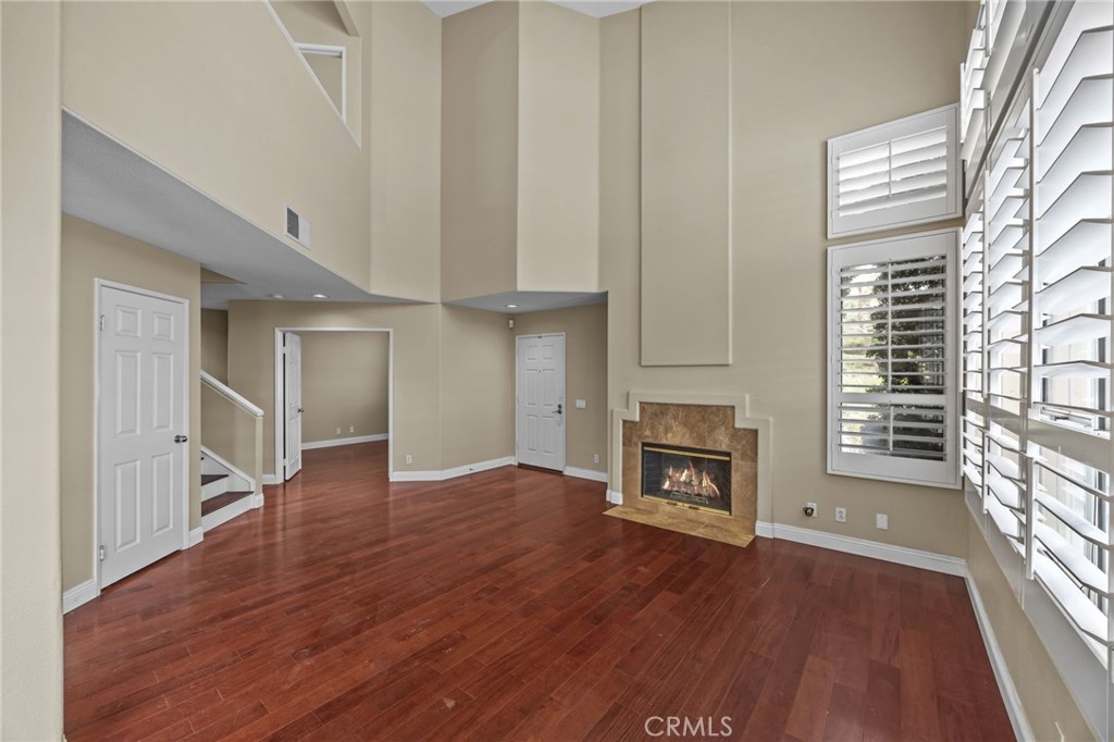 28677 La Azteca Laguna Niguel, CA 92677 - Photo 10 of 36 an empty room with wooden floor fireplace and windows