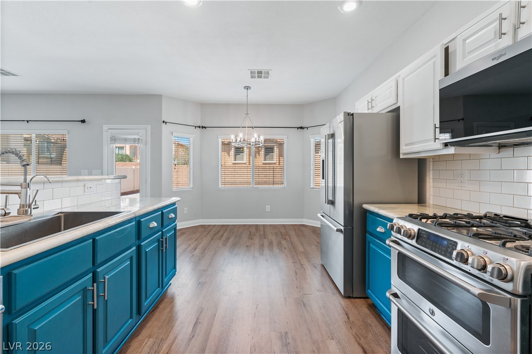 1328 Spice Ridge Court Henderson, NV 89012 - Photo 15 of 51 Bright and inviting kitchen with modern appliances and an open dining area.